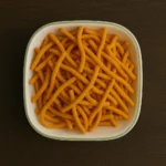 Freshly fried Minapappu Murukulu made from urad dal and rice flour.